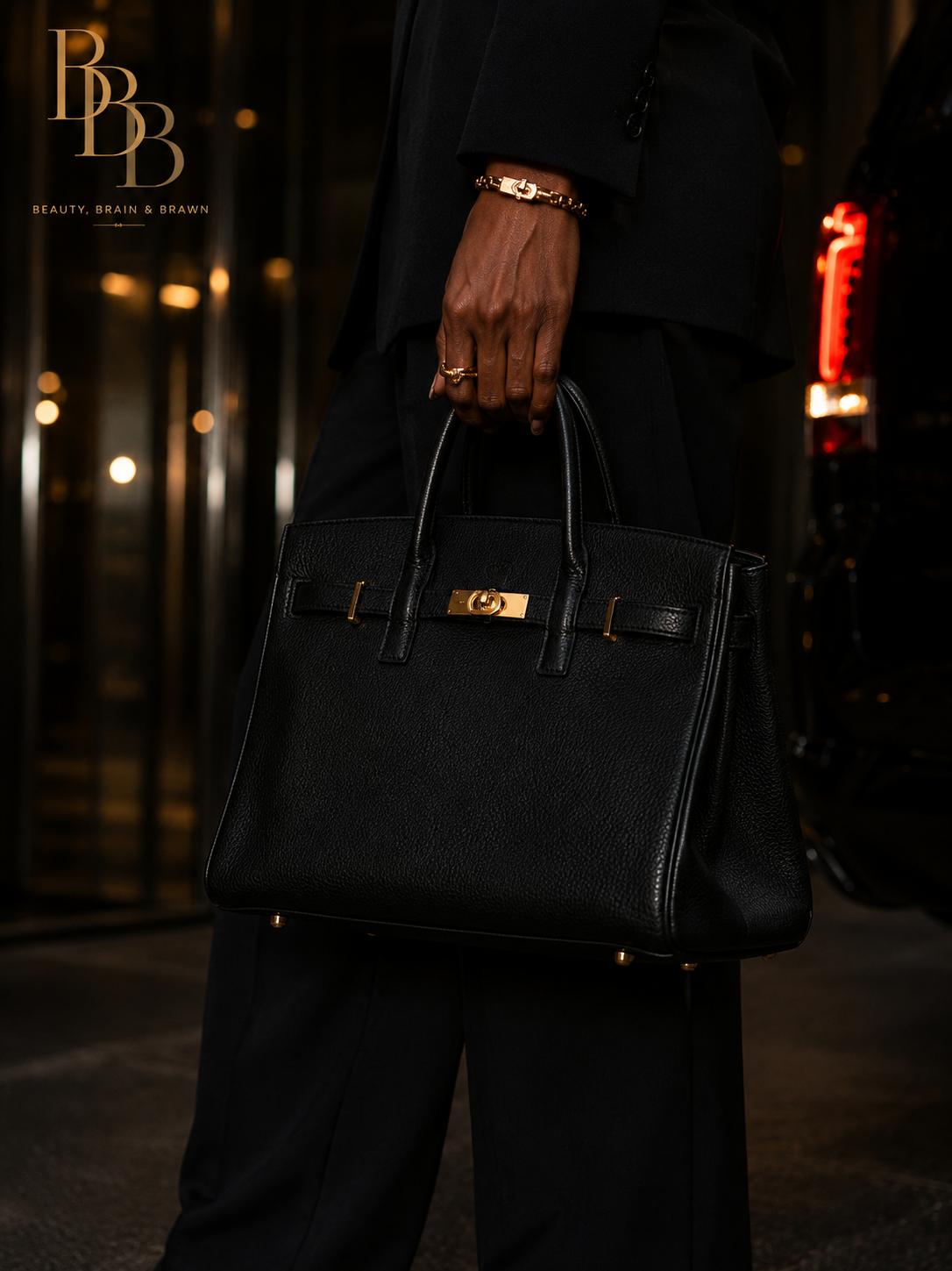 Structured black leather handbag detail