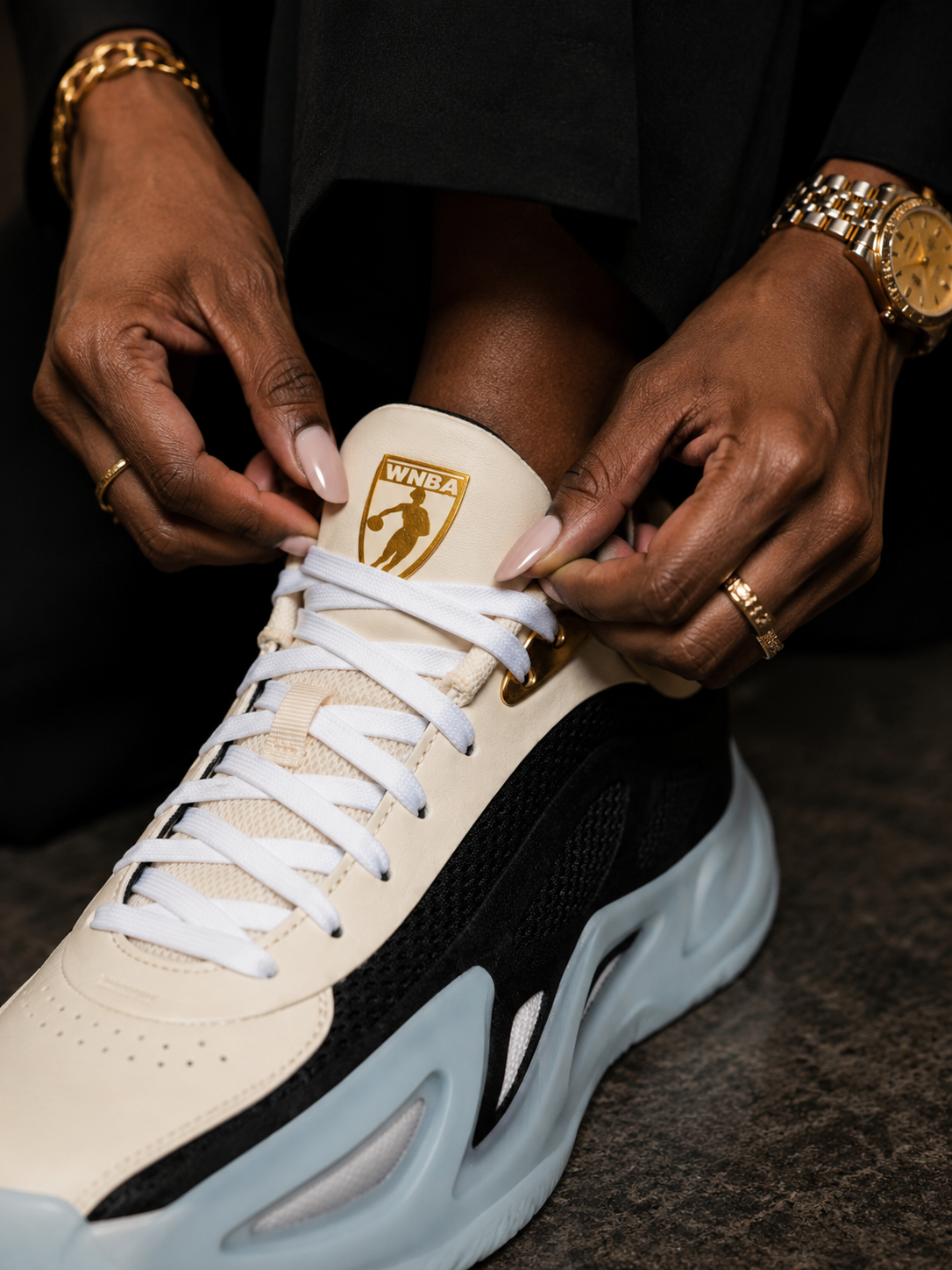 Sneaker adjusted with the gold WNBA emblem at the center of the frame